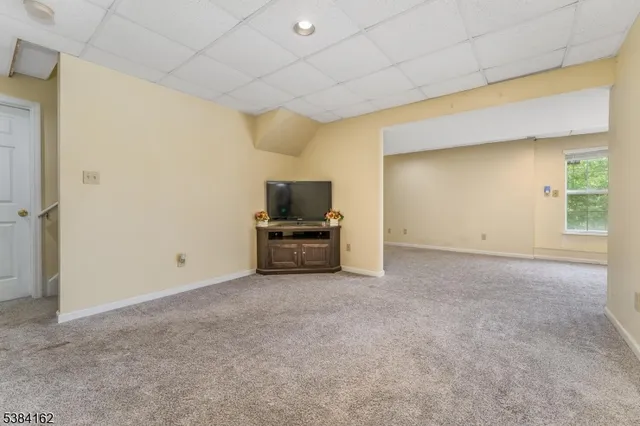 a view of an empty room with a kitchen