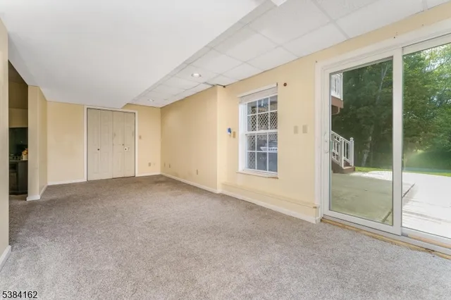 a view of an empty room with glass door