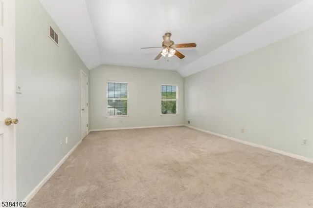 a view of a livingroom with a ceiling fan and window