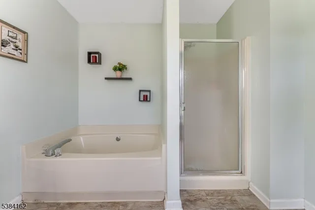 a white bath tub sitting next to a white sink