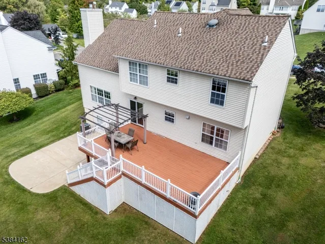 an aerial view of a house having patio with a garden