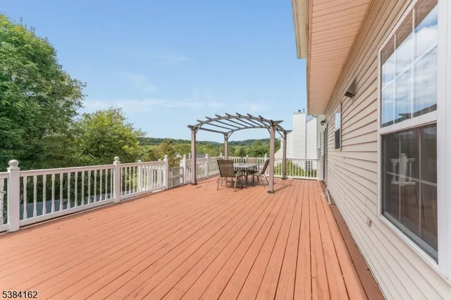 a view of a yard in front of a house with plants and entertaining space