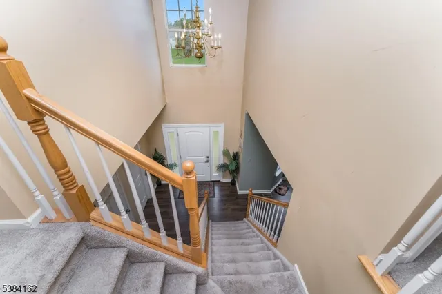 a view of staircase with railing and white walls