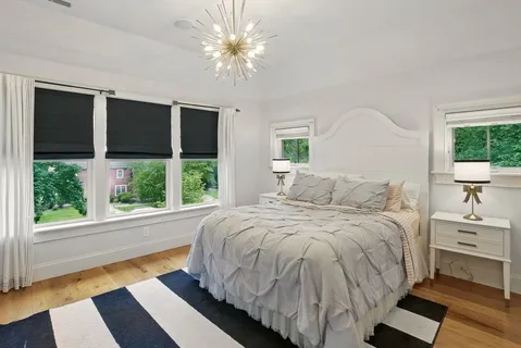 a bed sitting in a bedroom next to a window