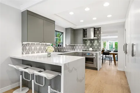 a kitchen with a sink cabinets and window