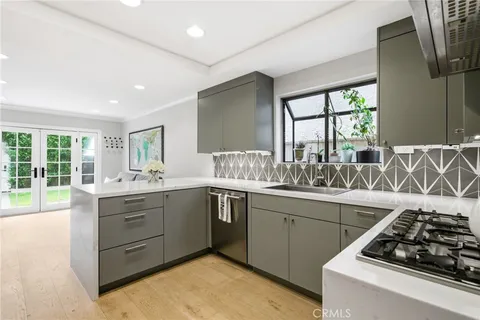 a kitchen with a stove a sink and a window