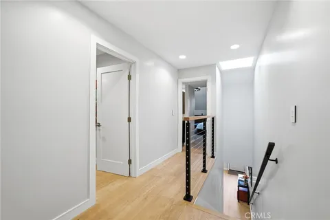 a bedroom with a large bed and a flat tv screen
