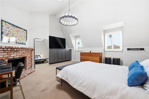 a spacious bedroom with a bed and a fireplace