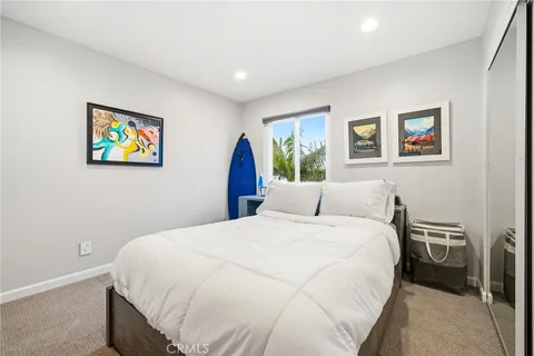 a large white bed in a white room