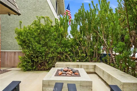 a view of a backyard with plants and brick wall