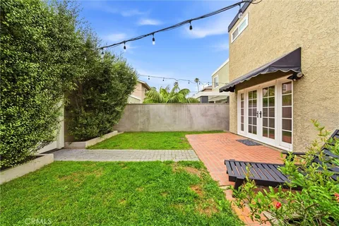a view of house with yard and sitting area