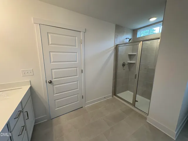 a bathroom with a shower and a sink