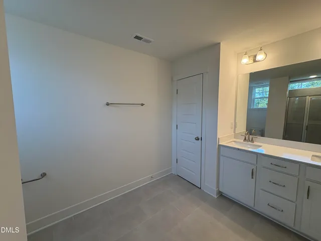 a bathroom with a granite countertop sink and mirror