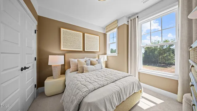 a bedroom with bed and a large window