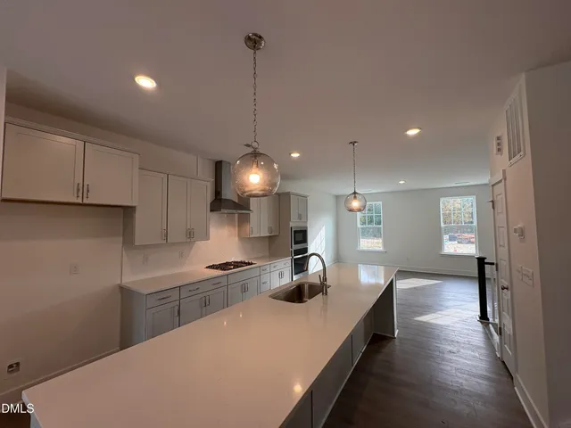 a kitchen with counter top space a sink stainless steel appliances and cabinets