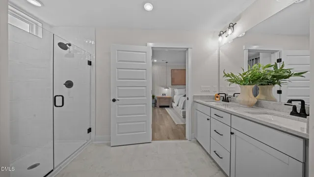 a bathroom with a shower sink and mirror