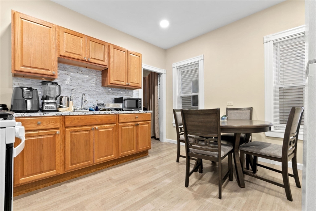 132 Vernal Street Everett, MA 02149 - Photo 13 of 22 a kitchen with a table chairs sink and cabinets