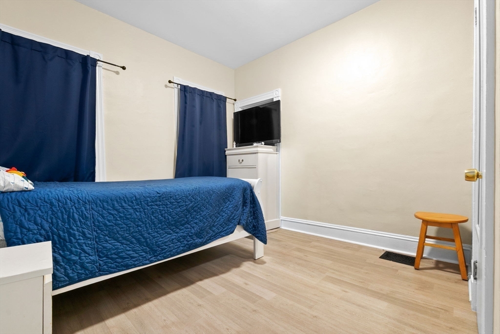 132 Vernal Street Everett, MA 02149 - Photo 17 of 22 a bedroom with a bed and a flat screen tv