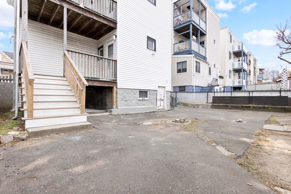 132 Vernal Street Everett, MA 02149 - Photo 19 of 22 a view of a house with a patio and a yard