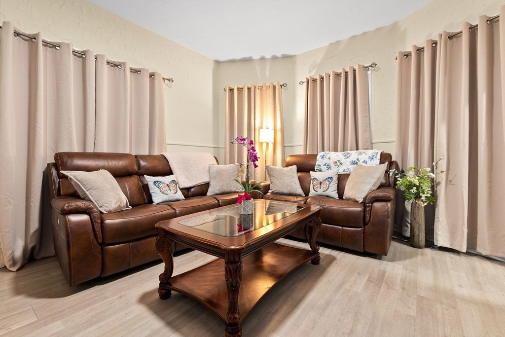 132 Vernal Street Everett, MA 02149 - Photo 6 of 22 a living room with furniture and a large window