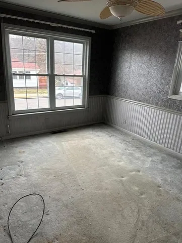 an empty room with a empty space and windows