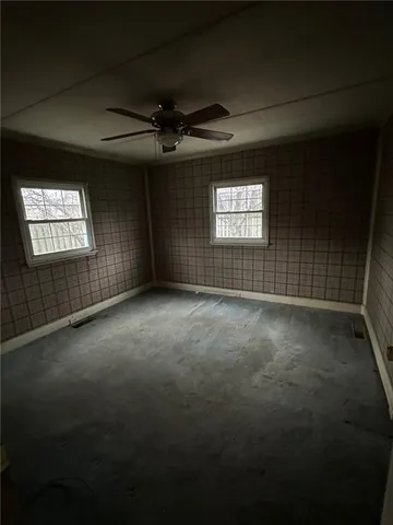 an empty room with a empty space and windows