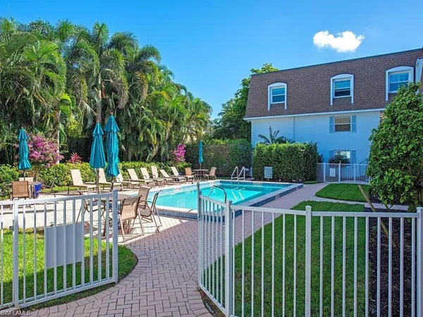 a view of a patio with couches table and chairs and potted plants