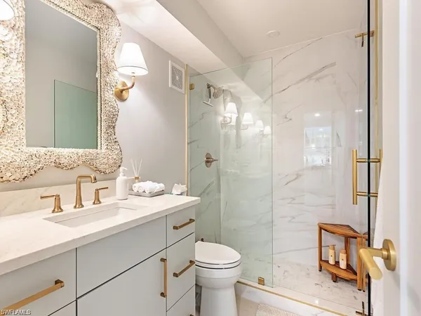 a bathroom with a sink toilet tub and shower