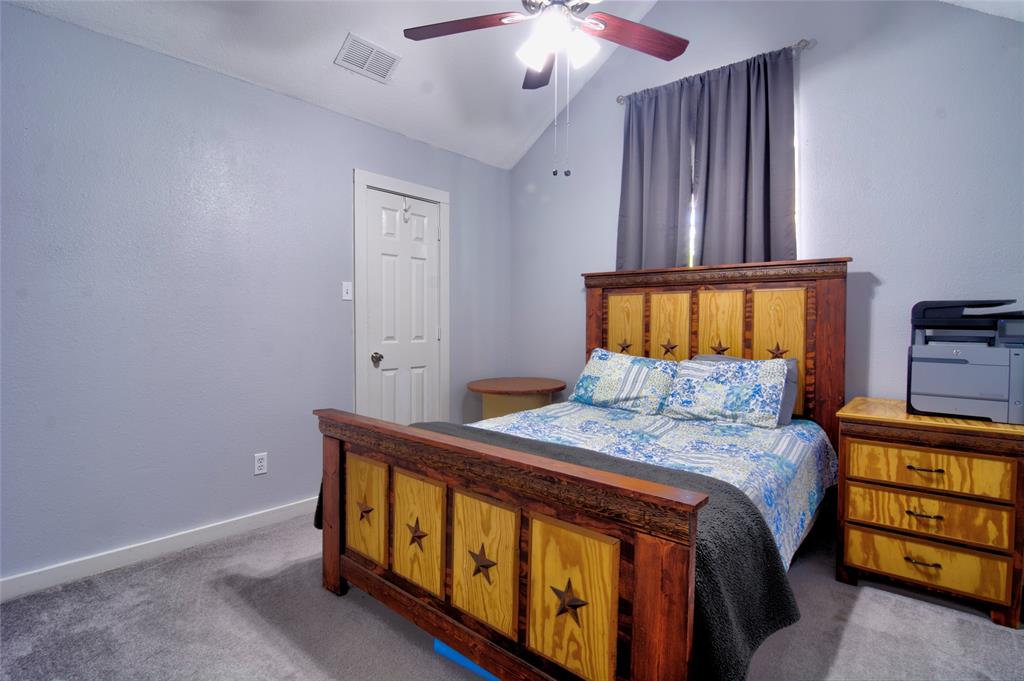 4825 Bobtown Road Garland, TX 75043 - Photo 14 of 17 a bedroom with a bed and a window