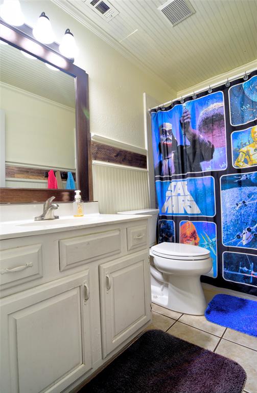 4825 Bobtown Road Garland, TX 75043 - Photo 15 of 17 a bathroom with a toilet a sink and a shower curtain