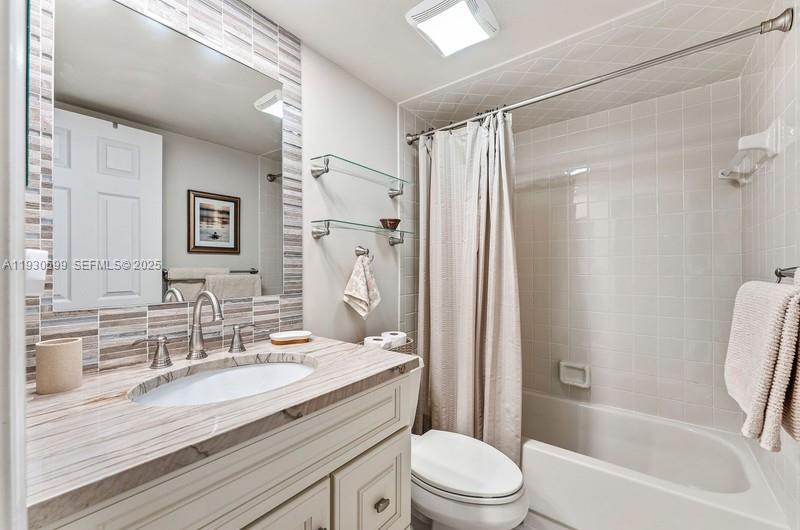 353 Highway 1, Unit C404 Jupiter, FL 33477 - Photo 12 of 30 a bathroom with a granite countertop sink toilet and shower