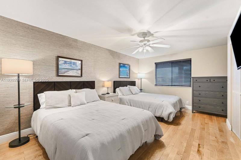 353 Highway 1, Unit C404 Jupiter, FL 33477 - Photo 13 of 30 a bedroom with two beds and a ceiling fan
