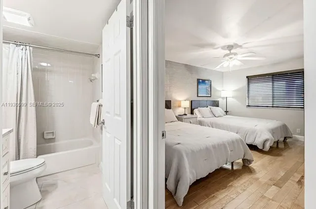 a spacious bedroom with a bed and a chandelier