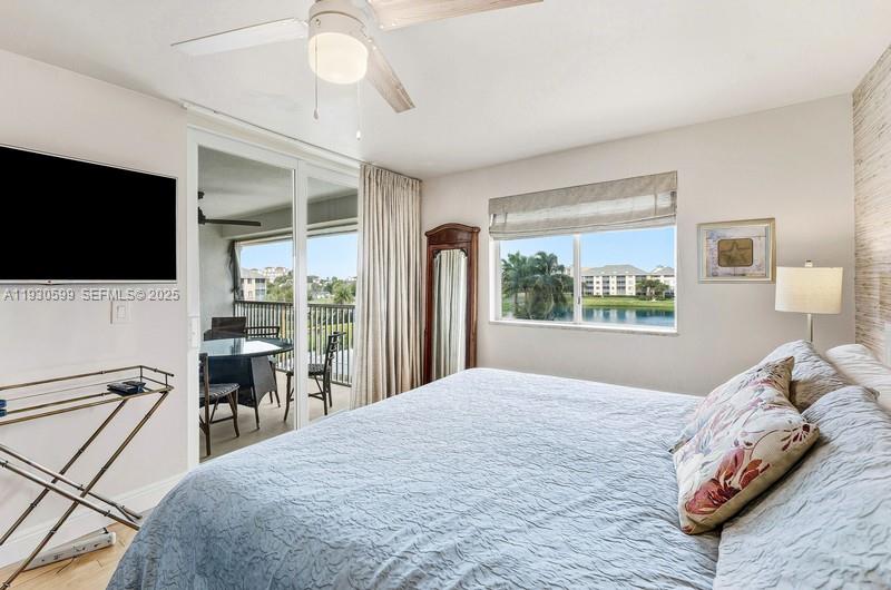 353 Highway 1, Unit C404 Jupiter, FL 33477 - Photo 17 of 30 a bedroom with a bed and a flat screen tv