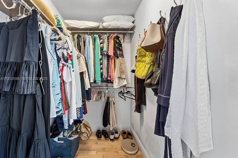 353 Highway 1, Unit C404 Jupiter, FL 33477 - Photo 19 of 30 a view of walk in closet with clothes and shoes