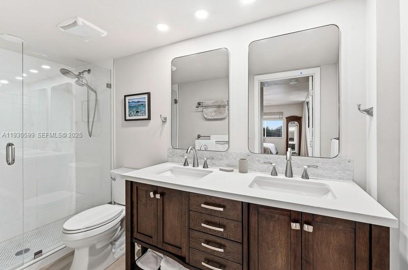 353 Highway 1, Unit C404 Jupiter, FL 33477 - Photo 20 of 30 a bathroom with a sink vanity mirror and toilet