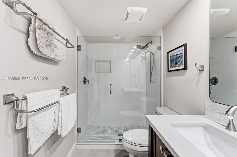 353 Highway 1, Unit C404 Jupiter, FL 33477 - Photo 21 of 30 a bathroom with a sink toilet and shower