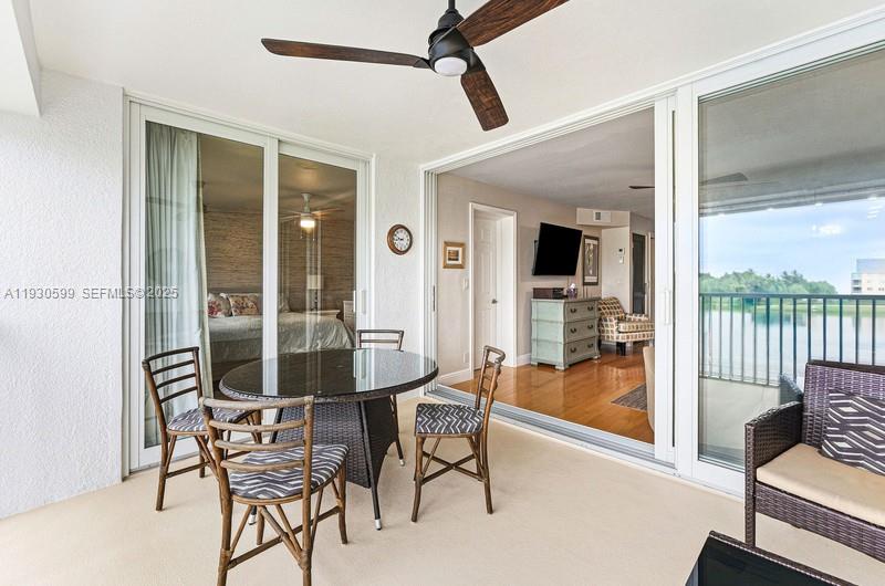 353 Highway 1, Unit C404 Jupiter, FL 33477 - Photo 23 of 30 a dining room with furniture and floor to ceiling windows