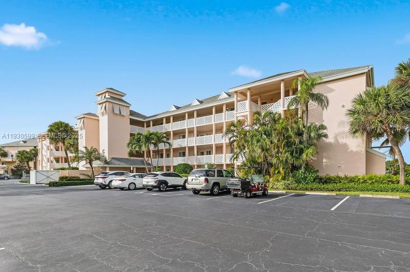 353 Highway 1, Unit C404 Jupiter, FL 33477 - Photo 25 of 30 a car parked in front of a building