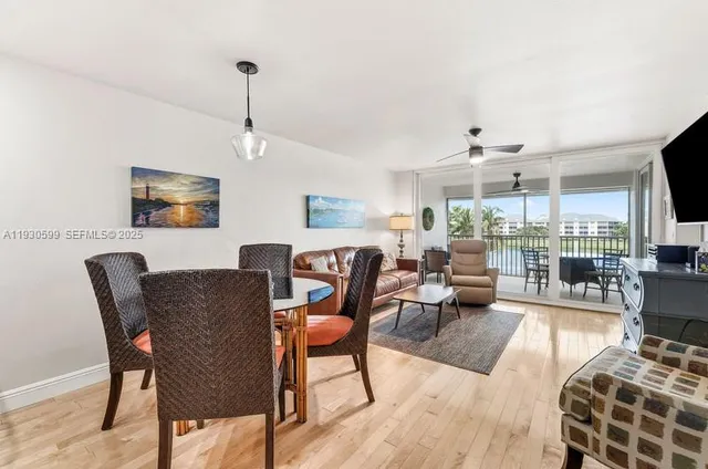 a living room with furniture a flat screen tv and kitchen view
