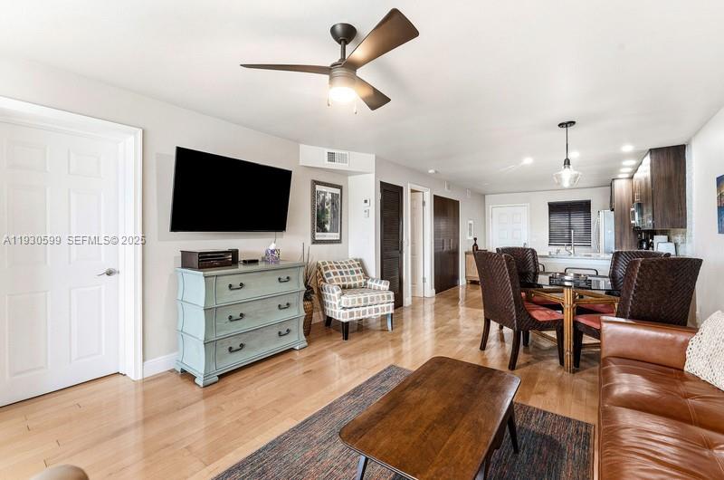 353 Highway 1, Unit C404 Jupiter, FL 33477 - Photo 6 of 30 a living room with furniture and a flat screen tv