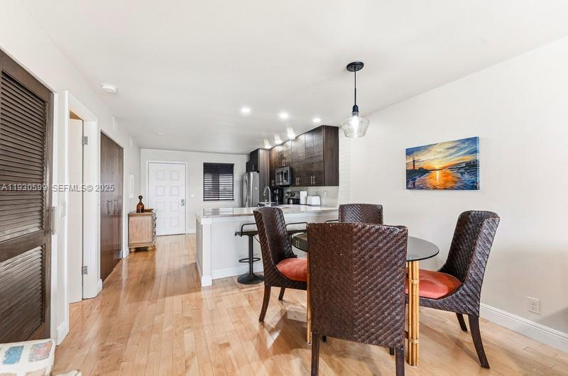 353 Highway 1, Unit C404 Jupiter, FL 33477 - Photo 7 of 30 a view of a dining room with furniture window and wooden floor