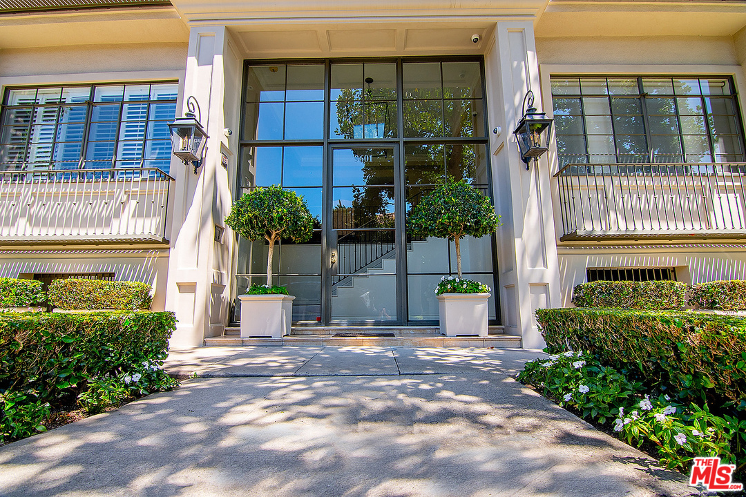 9601 Charleville Boulevard, Unit 8 Beverly Hills, CA 90212 - Photo 11 of 47 a view of a house with a garden