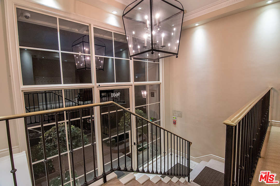 9601 Charleville Boulevard, Unit 8 Beverly Hills, CA 90212 - Photo 17 of 47 a view of staircase with railing and a window