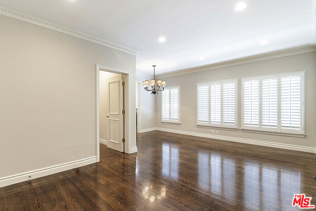 9601 Charleville Boulevard, Unit 8 Beverly Hills, CA 90212 - Photo 21 of 47 a view of an empty room with wooden floor and a window