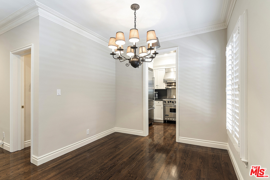 9601 Charleville Boulevard, Unit 8 Beverly Hills, CA 90212 - Photo 25 of 47 a view of a room with wooden floor chandelier and a window