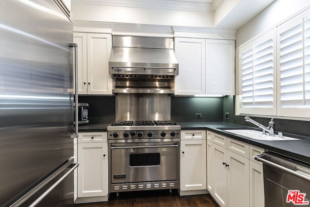 9601 Charleville Boulevard, Unit 8 Beverly Hills, CA 90212 - Photo 27 of 47 a kitchen with a stove and a sink