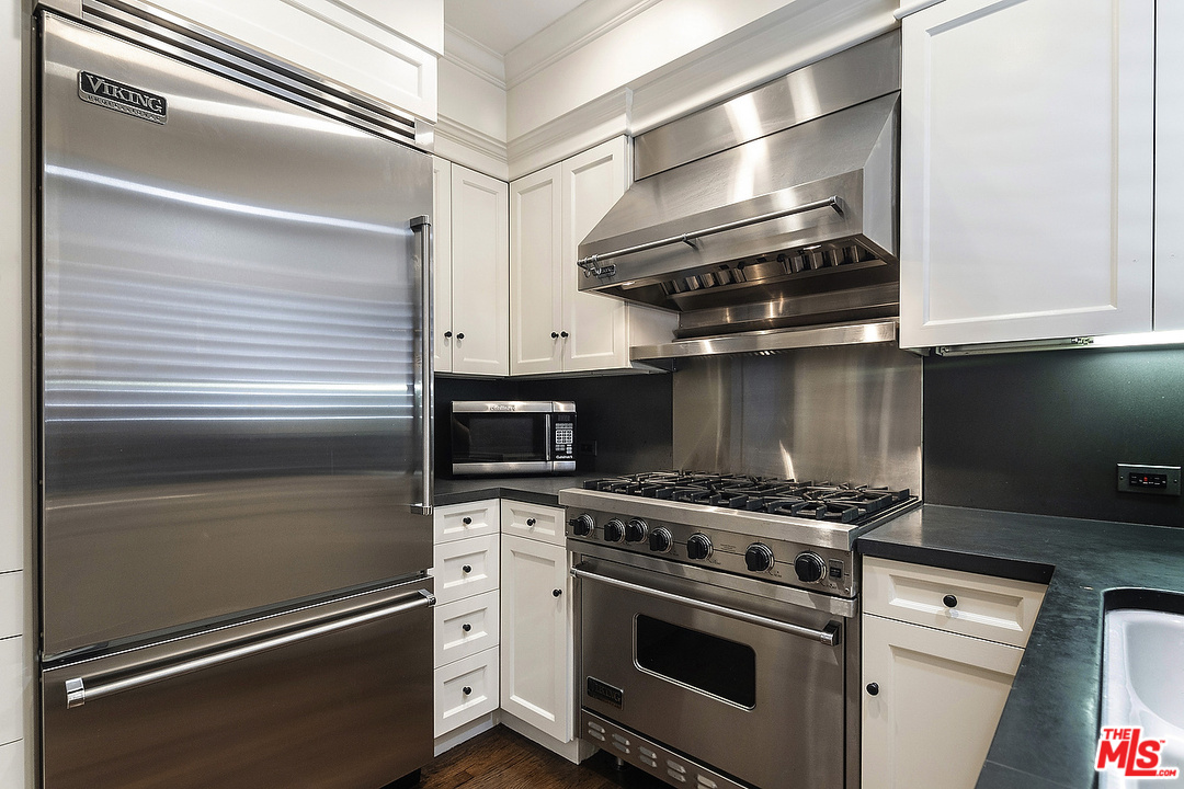 9601 Charleville Boulevard, Unit 8 Beverly Hills, CA 90212 - Photo 28 of 47 a kitchen with a stove and a microwave