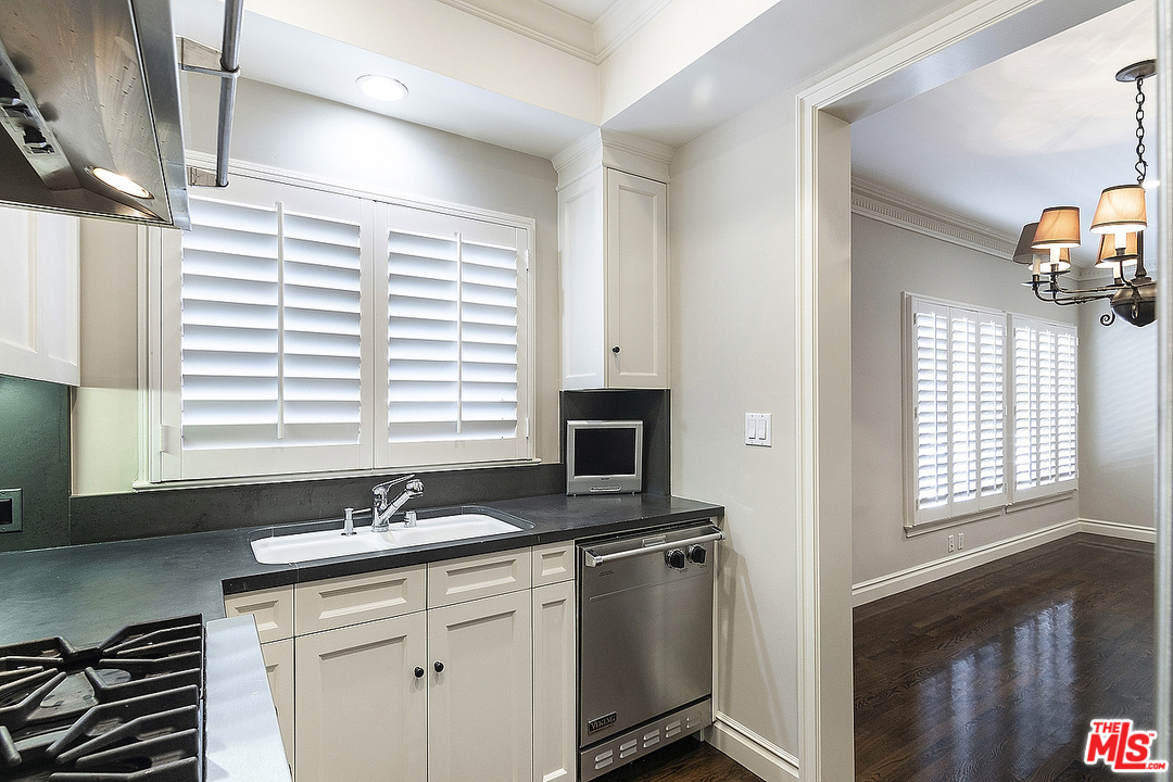 9601 Charleville Boulevard, Unit 8 Beverly Hills, CA 90212 - Photo 30 of 47 a kitchen with a sink cabinets and a window