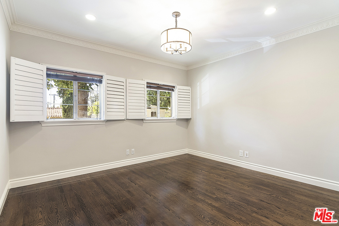 9601 Charleville Boulevard, Unit 8 Beverly Hills, CA 90212 - Photo 32 of 47 a view of a room with wooden floor and windows